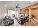 Living room with leather couches, a fireplace, and hardwood floors at 301 Inverness Way # 209, Englewood, CO 80112