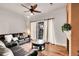 Living room with leather couches, a fireplace, and hardwood floors at 301 Inverness Way # 209, Englewood, CO 80112