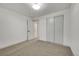 Spacious bedroom with plush carpeting and large closet at 1940 Samuel Dr, Denver, CO 80221