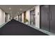 Building hallway with carpeting, elevator, and apartment doors at 12983 W Ida Ave # 307, Littleton, CO 80127