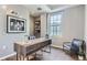 Bright home office features a large window, built-in shelving, and a spacious desk at 475 W 12Th Ave # 7G, Denver, CO 80204