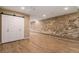 Living room with hardwood floors and exposed stone wall at 2944 Zuni St # B, Denver, CO 80211