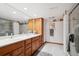 Basement bathroom boasts double sinks, a shower, and ample storage at 11144 Navajo St, Northglenn, CO 80234