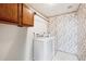 Convenient laundry room with washer, dryer, and overhead cabinets at 11144 Navajo St, Northglenn, CO 80234