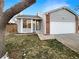 Ranch style home with attached garage and mature tree in front yard at 4635 Sable St, Denver, CO 80239