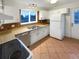 Kitchen with white cabinets, brick backsplash, and tile floor at 4635 Sable St, Denver, CO 80239