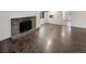 Open concept living room with hardwood floors and fireplace at 4635 Sable St, Denver, CO 80239