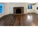 Bright living room features hardwood floors and a brick fireplace at 4635 Sable St, Denver, CO 80239