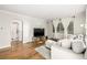 Living room with hardwood floors, a sofa and a view of the bathroom at 725 E Bayaud Ave, Denver, CO 80209