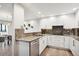 Modern kitchen with white cabinets and granite countertops at 3131 E Alameda Ave # 1107, Denver, CO 80209