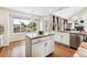 Bright kitchen features granite island, white cabinets, and a view from the window at 9324 W Hinsdale Pl, Littleton, CO 80128