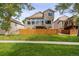 Back exterior view of two-story home and fenced yard at 9324 W Hinsdale Pl, Littleton, CO 80128