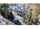 Elevated view of a modern house with deck, driveway, and snowy landscape near a road at 6270 Highway 9, Breckenridge, CO 80424