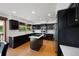 Modern kitchen with dark cabinetry, stainless steel appliances, and island at 20 Mesa Oak, Littleton, CO 80127