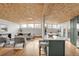 Open concept living area with a modern kitchen and wood-beamed ceiling at 3169 E Caley Ave, Centennial, CO 80121