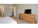 Bedroom with dresser and view of hallway at 11874 Barrentine Loop, Parker, CO 80138