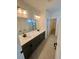 Modern bathroom with double vanity and walk-in shower at 2900 Nectar St, Strasburg, CO 80136