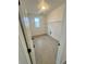 Bright laundry room with tile floors and window at 2900 Nectar St, Strasburg, CO 80136