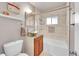 Updated bathroom with a vessel sink and tile shower/tub combo at 5442 S Cedar St, Littleton, CO 80120