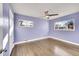 Spacious bedroom with hardwood floors and light purple walls at 5442 S Cedar St, Littleton, CO 80120