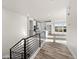 Modern staircase overlooking the main living area and kitchen at 8882 Whiteclover St, Littleton, CO 80125