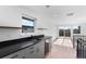 Modern wet bar with dark countertops and wine cooler at 1736 W 39Th Ave, Denver, CO 80211