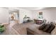 Comfortable living room with hardwood floors and a view into the dining area at 54686 E Bobcat Ln, Strasburg, CO 80136