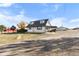 Ranch-style home with attached carport, large yard, and rural setting at 54686 E Bobcat Ln, Strasburg, CO 80136