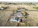 Aerial view of property showing house, outbuildings, and surrounding land at 54686 E Bobcat Ln, Strasburg, CO 80136