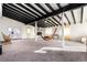 Spacious living room featuring exposed beams, a fireplace, and a hammock at 54686 E Bobcat Ln, Strasburg, CO 80136