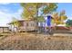 Large backyard with tree, playset and deck at 54686 E Bobcat Ln, Strasburg, CO 80136