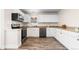 Modern kitchen with white cabinets and granite countertops at 54686 E Bobcat Ln, Strasburg, CO 80136