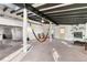 Bright living room with high ceilings, exposed beams, and a view into the kitchen at 54686 E Bobcat Ln, Strasburg, CO 80136