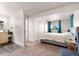 Main bedroom with large bed, ensuite bathroom access, and a window with view at 54686 E Bobcat Ln, Strasburg, CO 80136