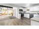 Open concept kitchen with a view of the living room and access to other rooms at 54686 E Bobcat Ln, Strasburg, CO 80136