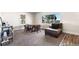 Cozy dining area with wood table and chairs, and a comfortable chaise lounge at 54686 E Bobcat Ln, Strasburg, CO 80136