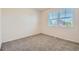 Well-lit bedroom with gray carpeting and two windows at 25266 E Lake Dr, Aurora, CO 80016