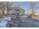 Two-story building exterior with parking area and snow on the ground at 8035 W Eastman Pl # 104, Lakewood, CO 80227