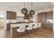 Modern kitchen with wood cabinetry, quartz countertops and breakfast bar at 6196 Oxford Peak Ln, Castle Rock, CO 80108