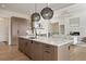 Modern kitchen with large island, stainless steel appliances, and ample counter space at 6196 Oxford Peak Ln, Castle Rock, CO 80108