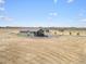 Aerial view of a ranch home on a large lot with outbuildings at 1570 S County Road 129, Bennett, CO 80102