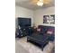 Living room featuring leather reclining sofa, coffee table and large TV at 15171 E 118Th Ave, Commerce City, CO 80603