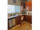 Kitchen corner with sink, dishwasher and wood cabinets at 15171 E 118Th Ave, Commerce City, CO 80603