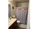 Clean bathroom with double vanity and floral shower curtain at 15171 E 118Th Ave, Commerce City, CO 80603