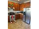 Kitchen with stainless steel appliances and wood cabinets at 15171 E 118Th Ave, Commerce City, CO 80603