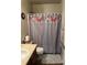 Clean bathroom with double vanity and floral shower curtain at 15171 E 118Th Ave, Commerce City, CO 80603