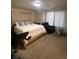 Spacious main bedroom with king-size bed and recliner at 15171 E 118Th Ave, Commerce City, CO 80603