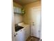 Bright laundry room with washer, dryer, and shelving at 15171 E 118Th Ave, Commerce City, CO 80603