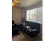Living room with black leather reclining sofa and large window at 15171 E 118Th Ave, Commerce City, CO 80603