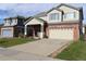 Two-story house with a covered porch and landscaping at 15171 E 118Th Ave, Commerce City, CO 80603